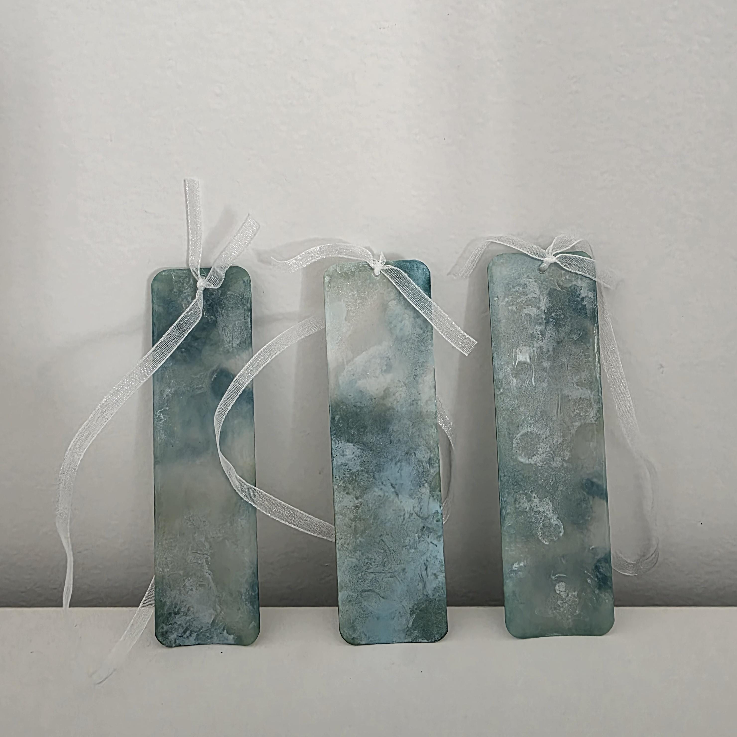 Set of three soft teal and seafoam green alcohol ink bookmarks with delicate white ribbons
