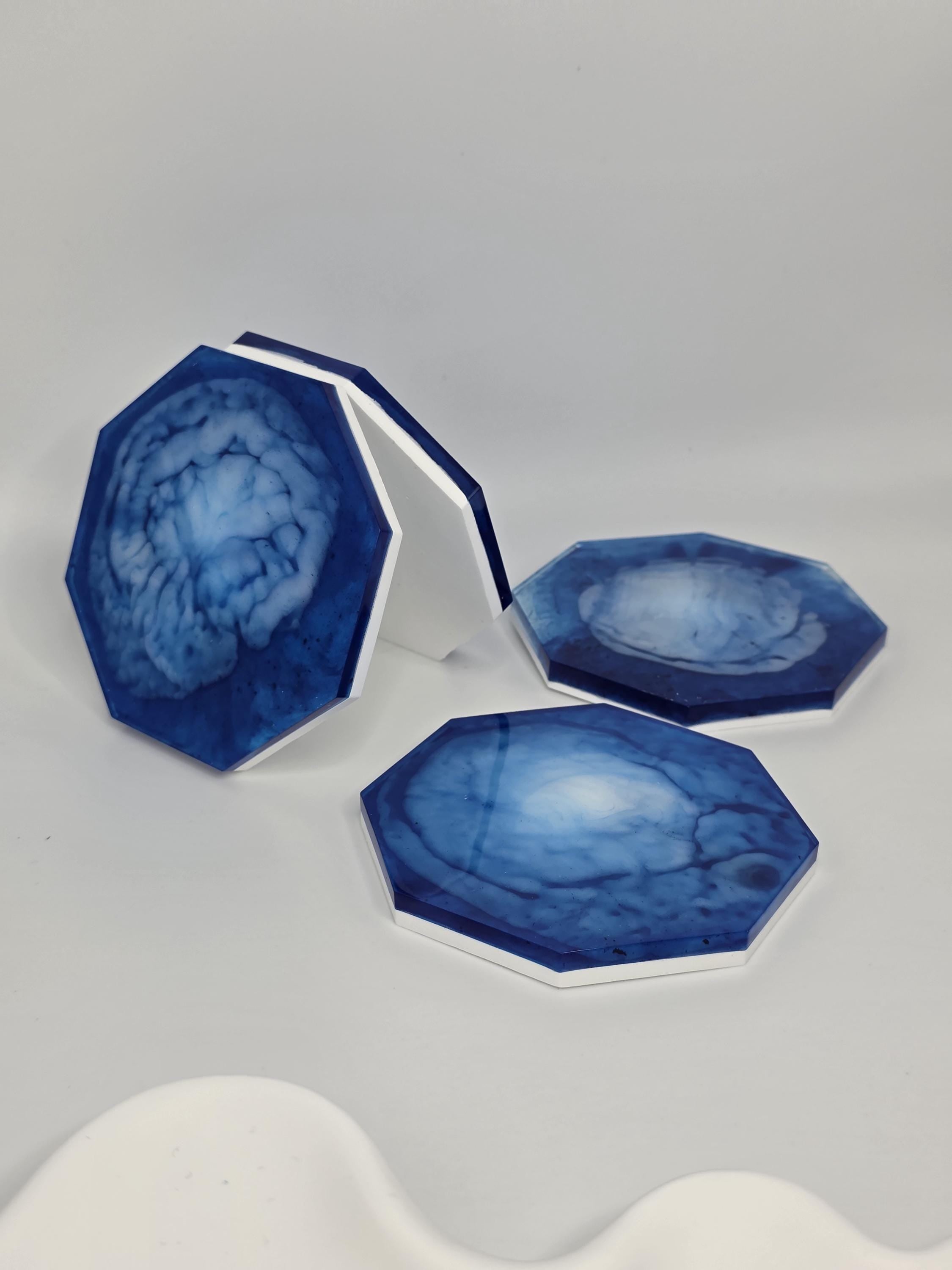 Side profile of a coaster highlighting the contrast between the glossy blue resin and the matte white base.