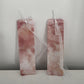 Close-up of two warm rose and terracotta alcohol ink bookmarks showing the glossy UV resin coating