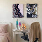 Two framed abstract mixed-media canvas artworks hanging above a white study desk in a child's bedroom.