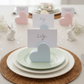 Easter table setting with heart-shaped place cards and bunny decorations.