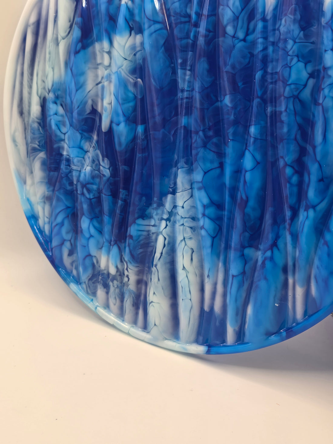 Side profile showing the high-gloss finish and the depth of the blue and white resin swirls.