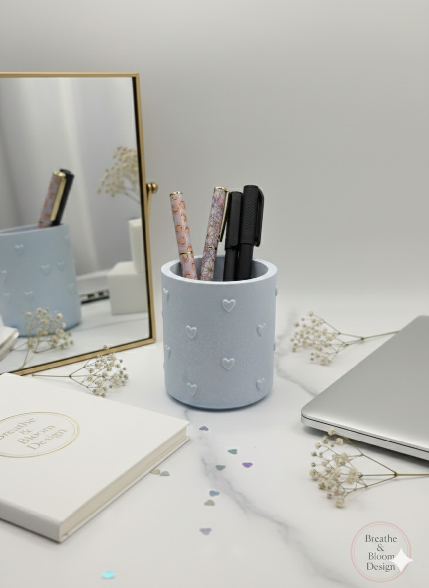 Soft Sky Blue pastel pen holder with pens on a desk with a laptop and notebook.