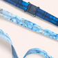 Close-up of a black plastic quick-release safety breakaway clasp on a dark blue patterned lanyard.